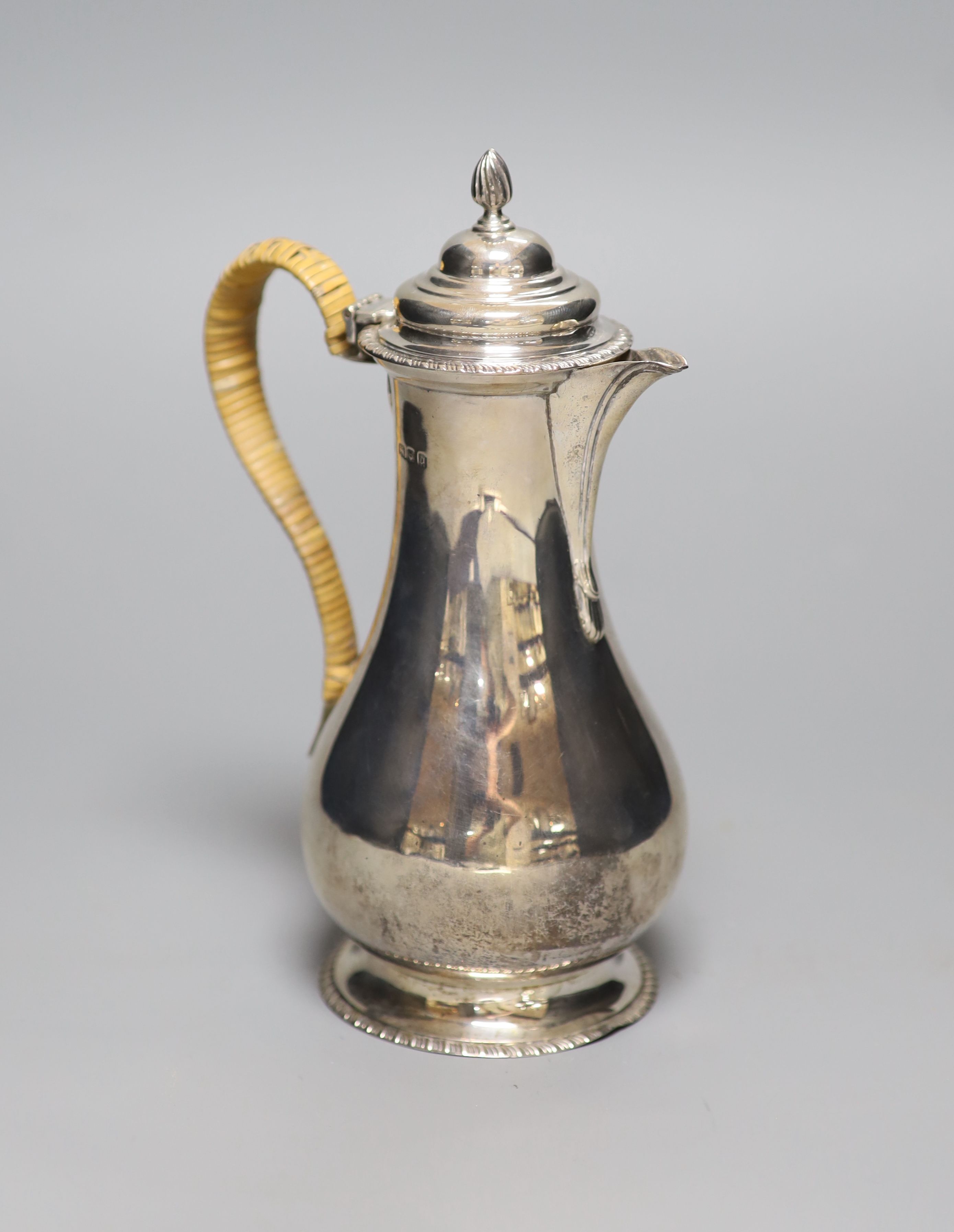 A George V silver hot water pot with rattan handle, London, 1919